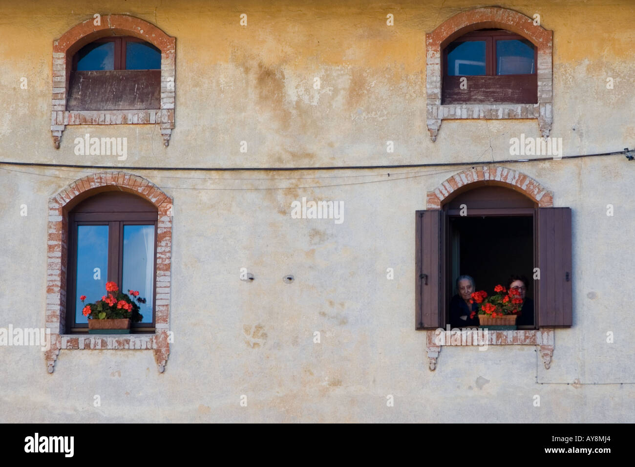 Stock Photo of Spectators Watching a Parade Through Windows in Their ...