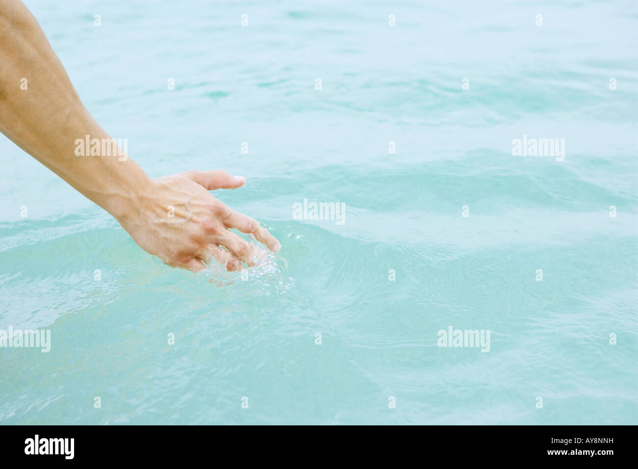 Hand touching water, close-up Stock Photo