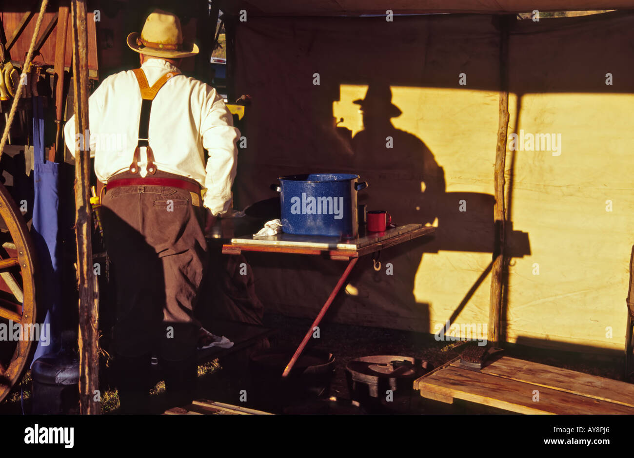A cowboy chuckwagon cook and his early morning shadow, at the Lincoln