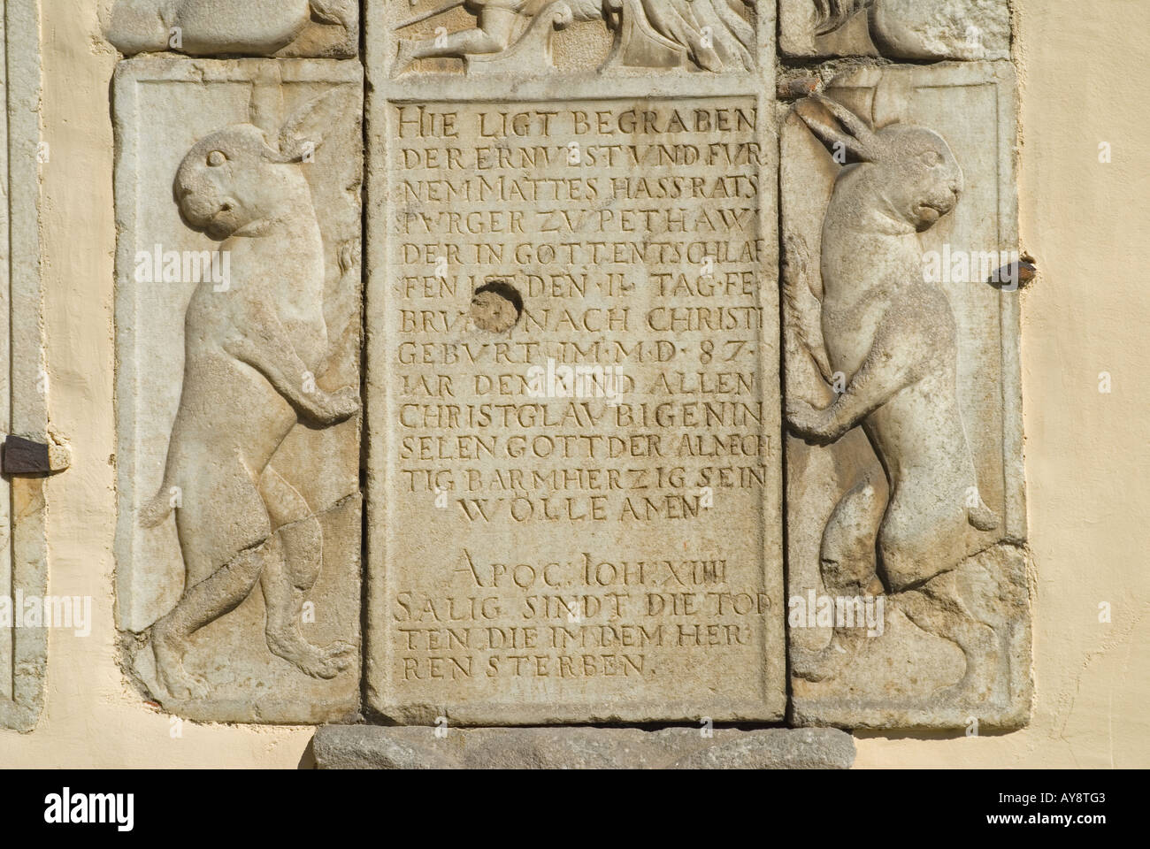 Ptuj, Stajerska, Slovenia. 17thC plaque on exterior wall of St George's Church in archaic German, commemorating burial Stock Photo