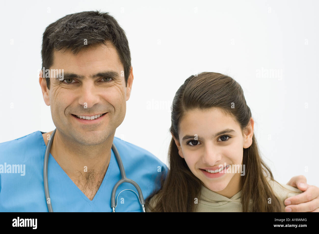 Male doctor with arm around girl's shoulder, both smiling at camera