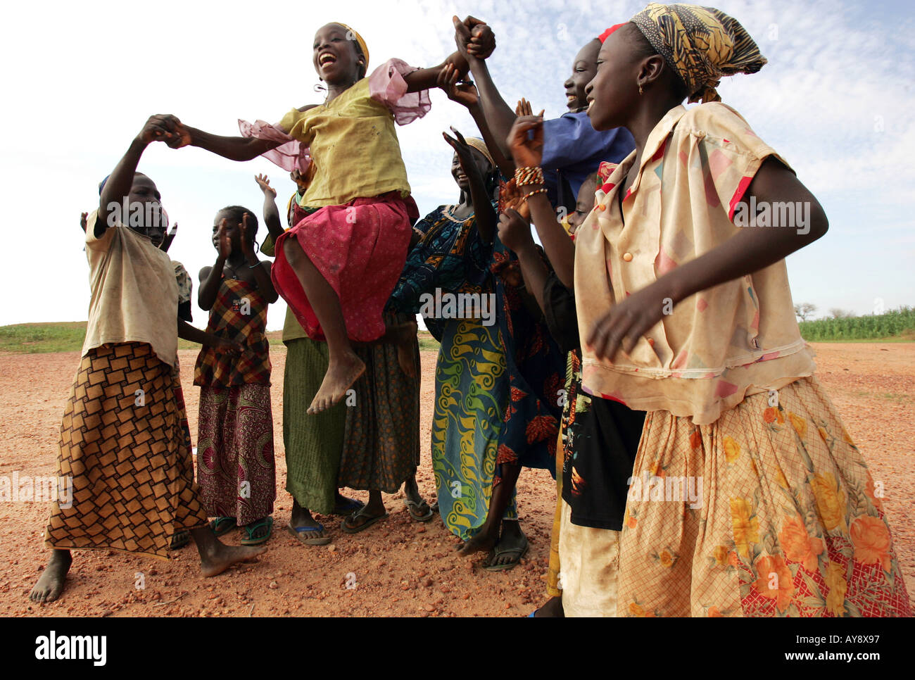 YOUNG GIRLS PERFORM A RAIN DANCE IN DESPERATE HOPE FOR RAIN TO HELP THE WILTING CROPS GROW IN A   VILLIAGE  NEAR THE FAMINE STRI Stock Photo