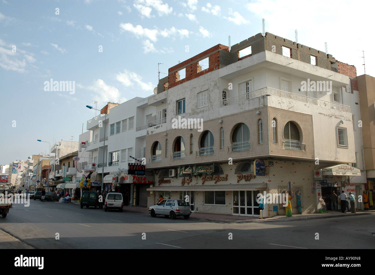 House of flats and street with restaurants and shops in Sousse city in