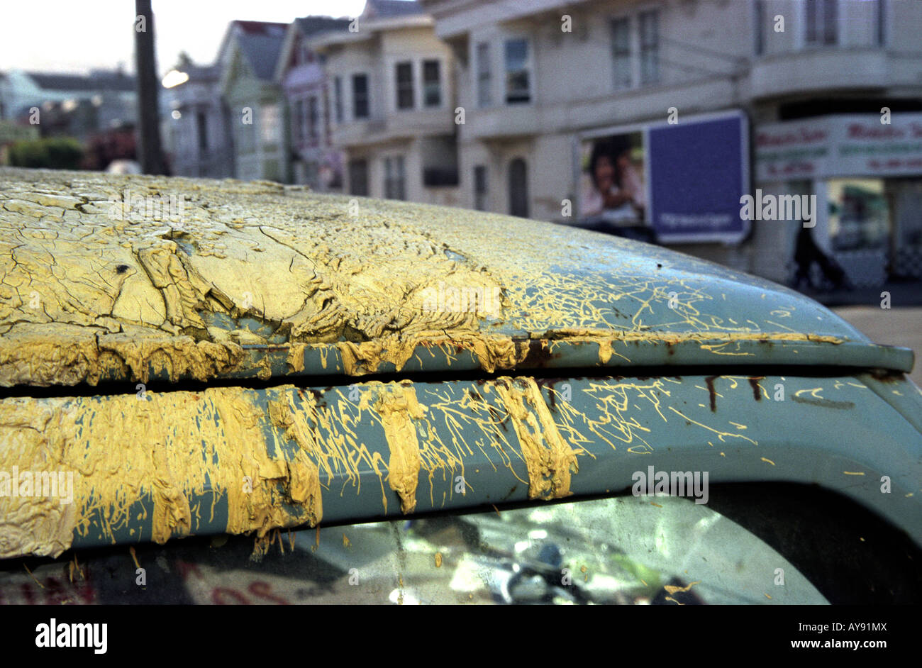Cracked yellow paint atop a car in San Francisco, California Stock