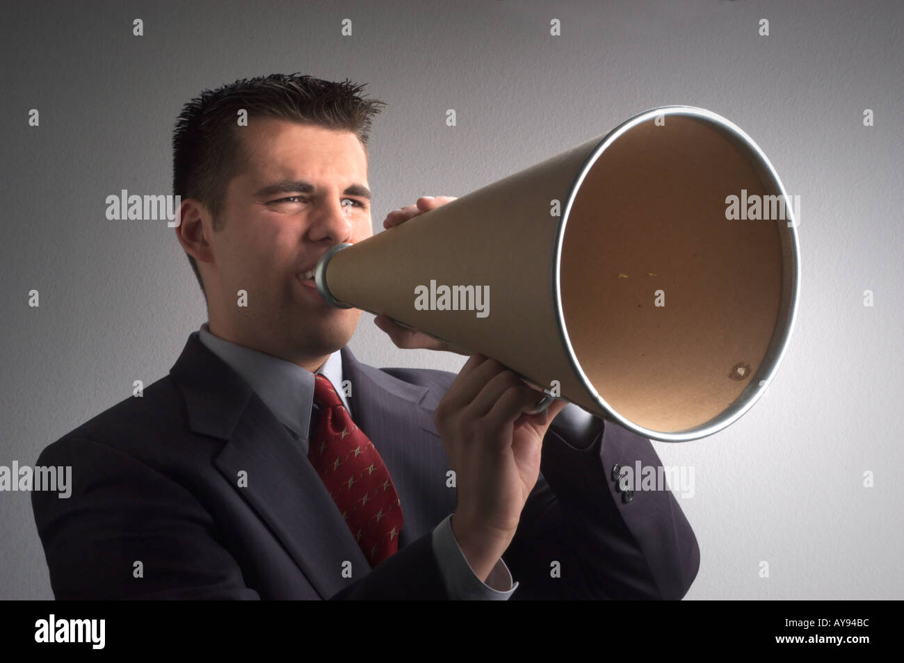 Young business man yelling through a megaphone Stock Photo Alamy