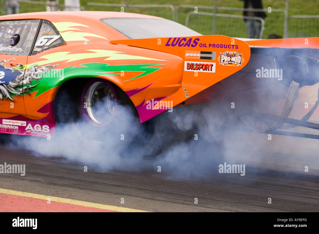 Wheel spin and smoke on dragster racing car at Santa Pod, UK Stock