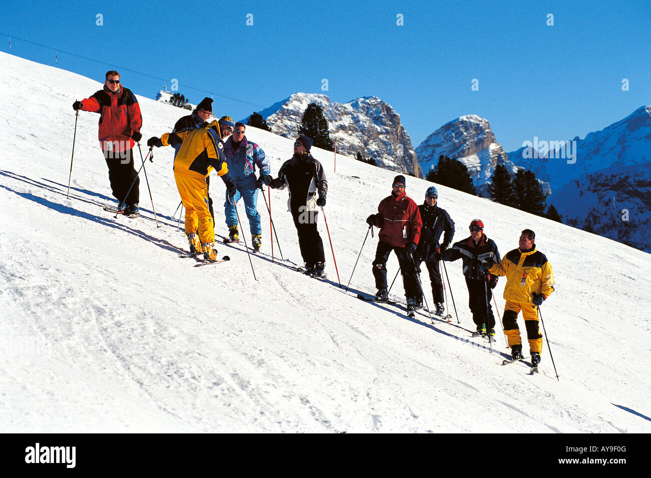 Men in ski lesson on slopes of Passo de Gardena, Selva Gardena, Italy Stock Photo