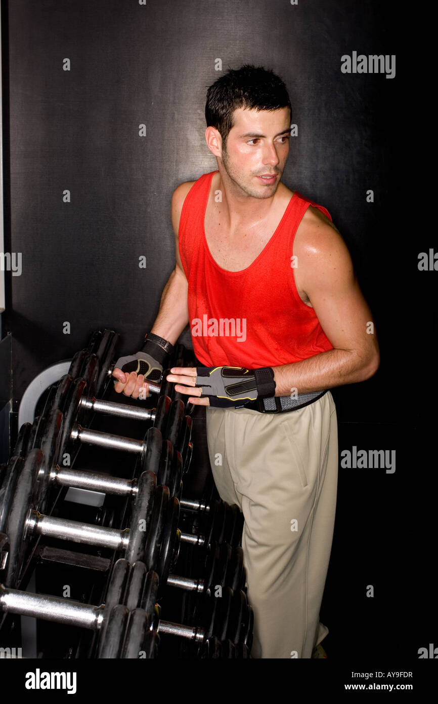 Young man weight training in a gym Stock Photo - Alamy