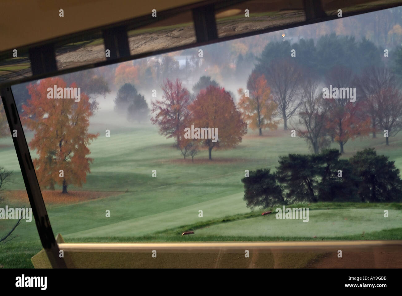 Morning mist golf buggy course cart  view , fall trees, green fairway green Philmont Golf Club Bryn Athyn, PA Stock Photo