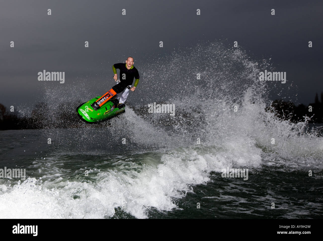 Jet skier mid air action stunt with water spray Stock Photo