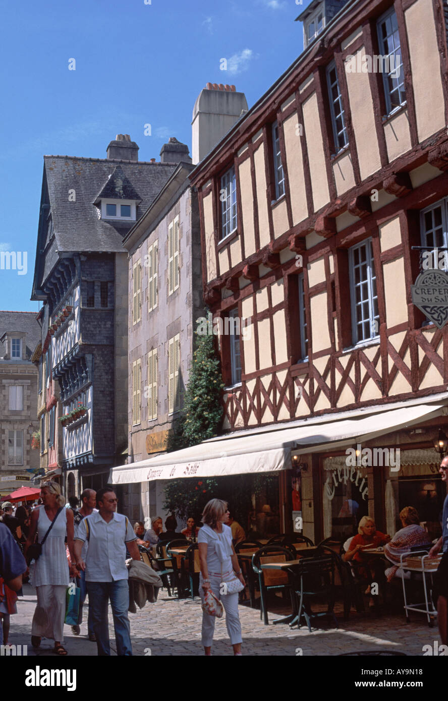 Historic medieval buildings in one of the busy shopping streets of Old Quimper, Brittany, France Stock Photo