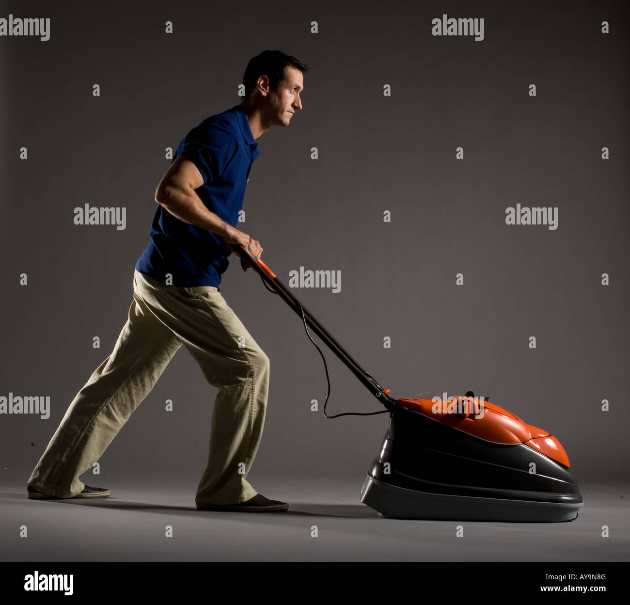 MAN PUSHING FLYMO VISION COMPACT 330 LAWNMOWER Stock Photo