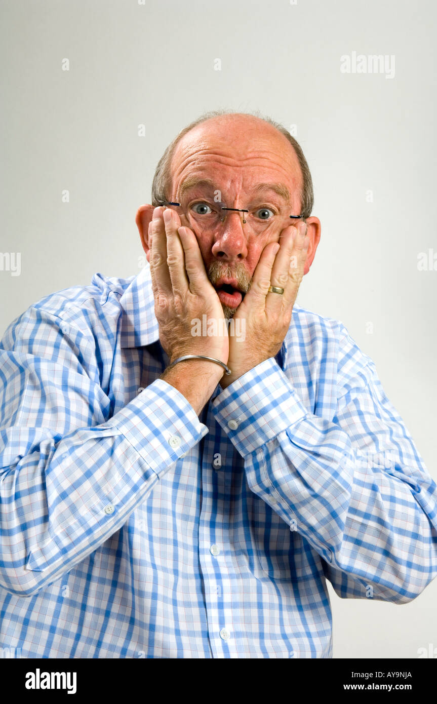 60 year old white man with a a goatee beard and a  facial expression depicting horrifed surprise Stock Photo