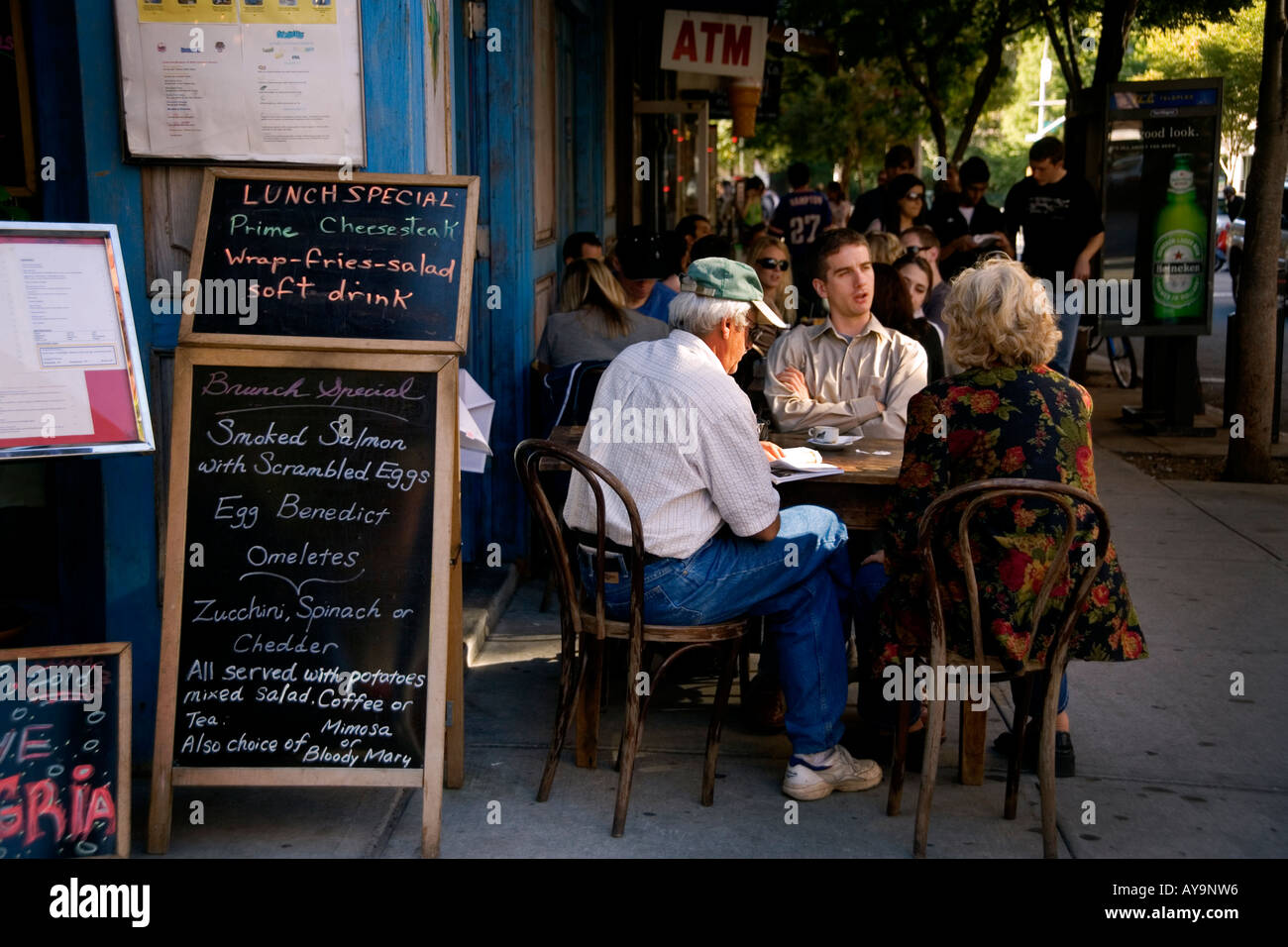 A family lunches outdoors at a sidewalk cafe in the SoHo district South