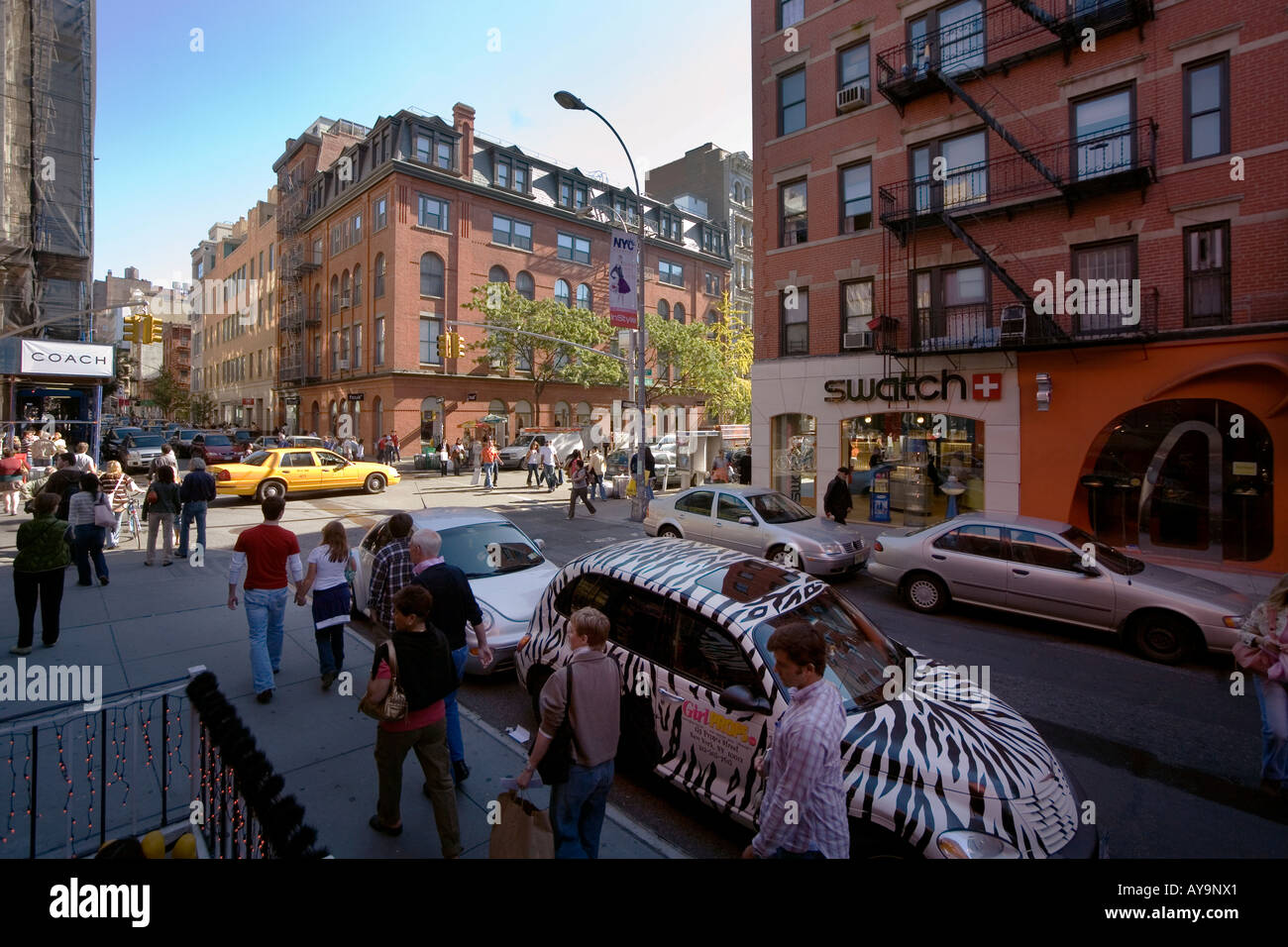 Sunday strollers pass upscale shops on Prince Street in the SoHo district South of Houston