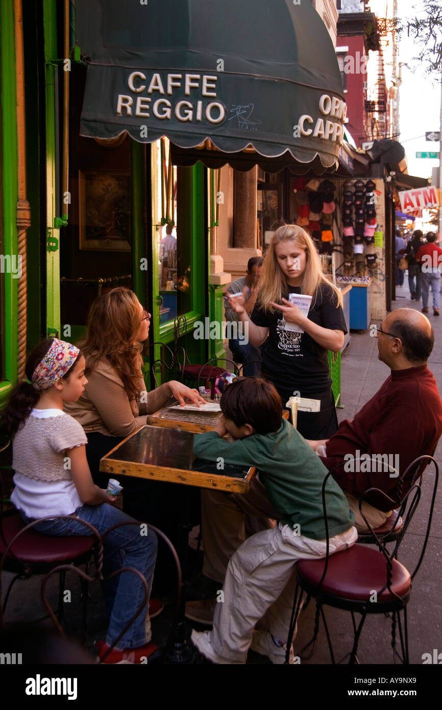 A family eats lunch outdoors at the Cafe Reggio on MacDougal Street in Greenwich Village Manhattan New York City Stock Photo