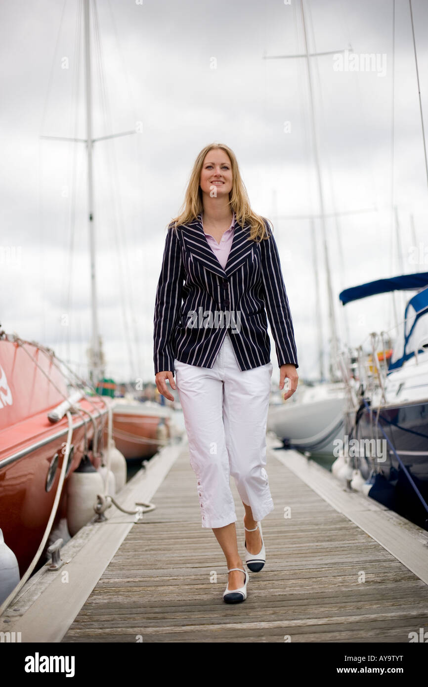 Woman in striped jacket on pier, nautical fashion, Cowes, Isle of Wight, UK Stock Photo