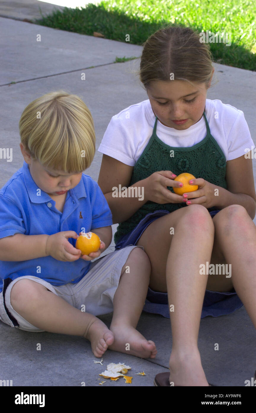 kids peeling tangerines Stock Photo Alamy