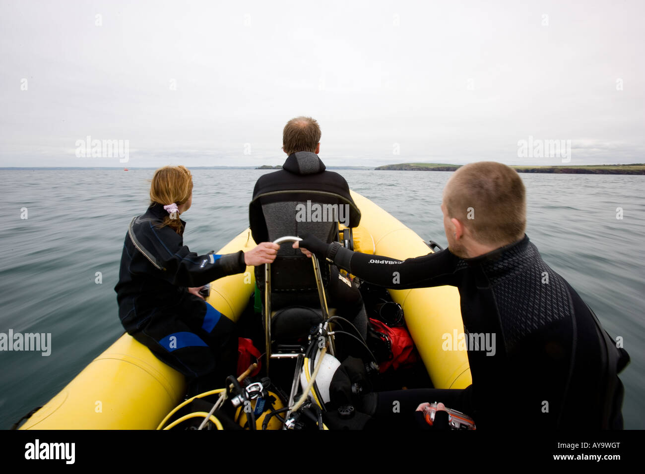 Scuba divers head out to sea, Pembrokeshire, Wales Stock Photo