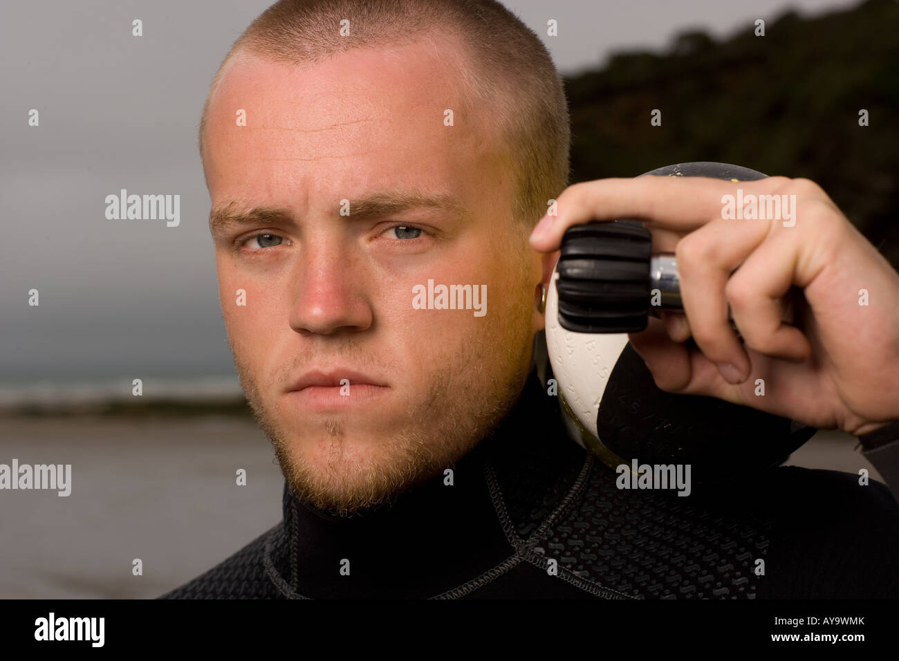 Scuba diver holding tank on shoulder, serious portrait Stock Photo