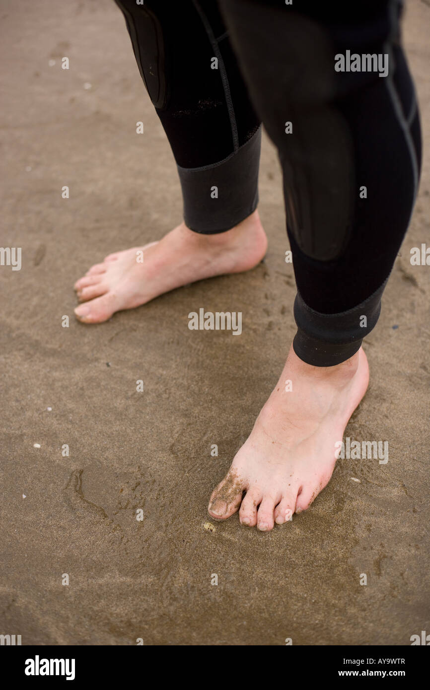 Scuba divers cold feet on wet sand Stock Photo