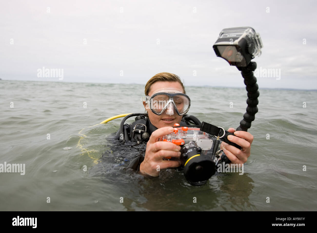 Scuba diver adjusting camera in diving mask Stock Photo