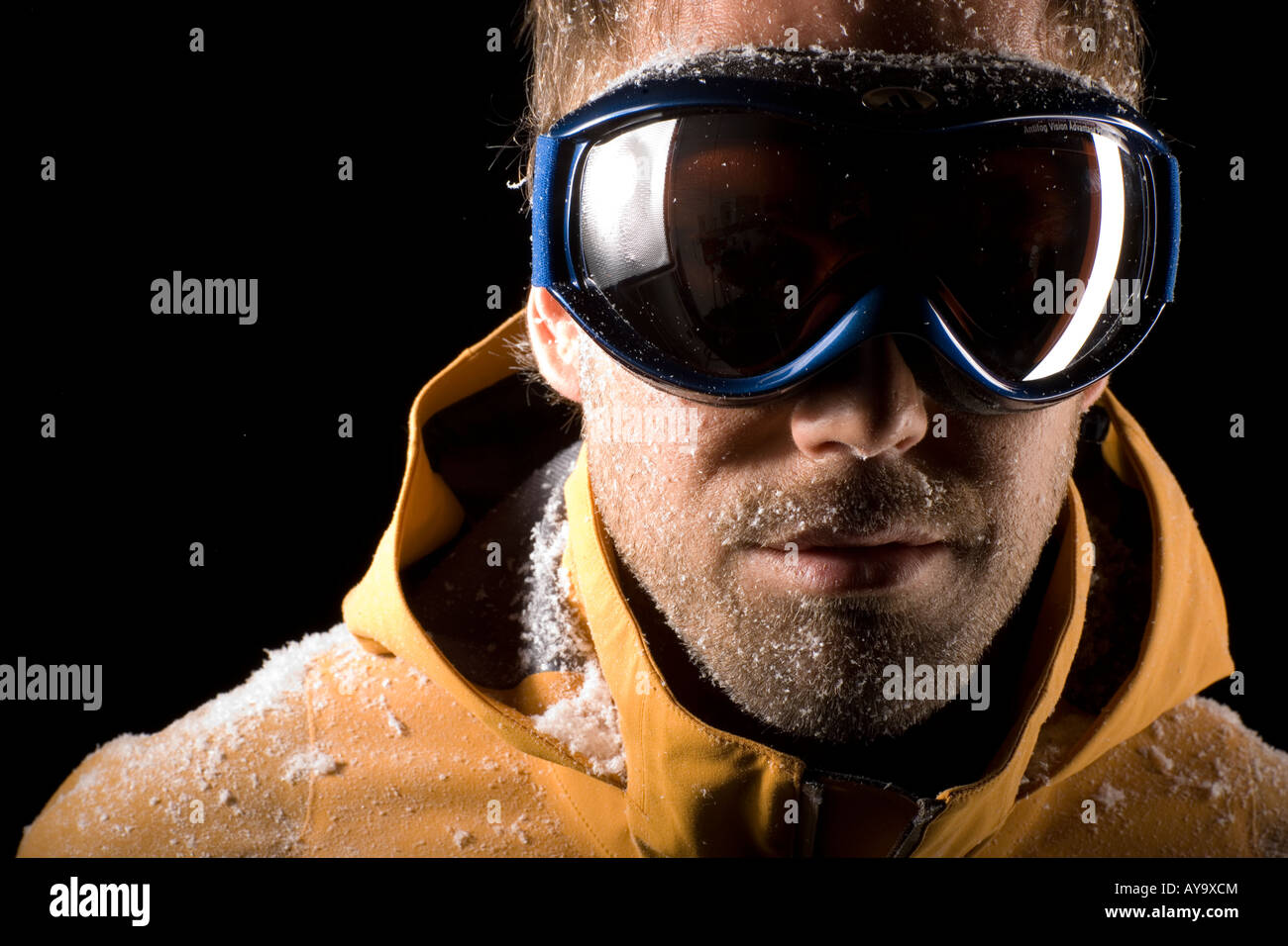Man modelling ski goggles in artificial snow Stock Photo Alamy