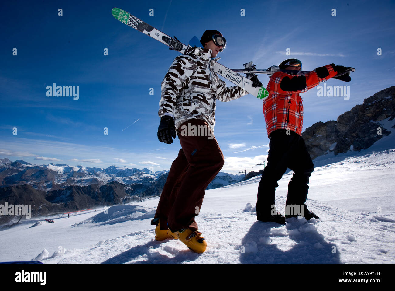 Skiers carrying equipment uphill, Tignes, France Stock Photo