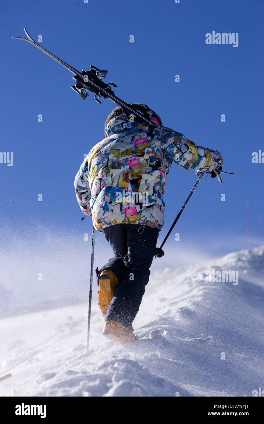 Skier carrying equipment uphill, Tignes, France Stock Photo