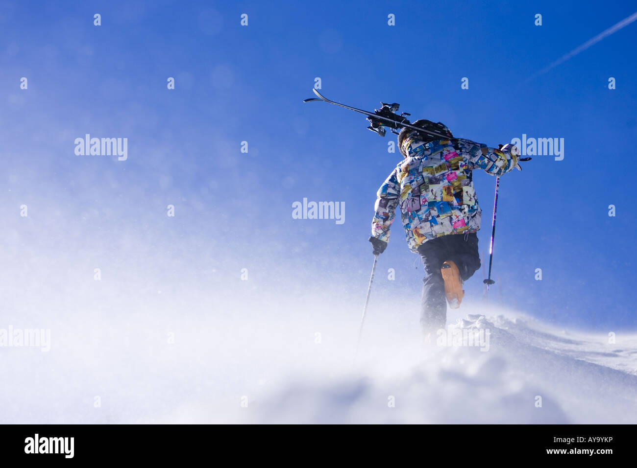 Skier carrying equipment uphill, Tignes, France Stock Photo