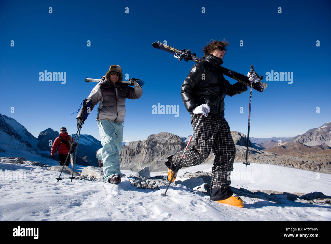 Skiers carrying skis on shoulders, Tignes, France Stock Photo