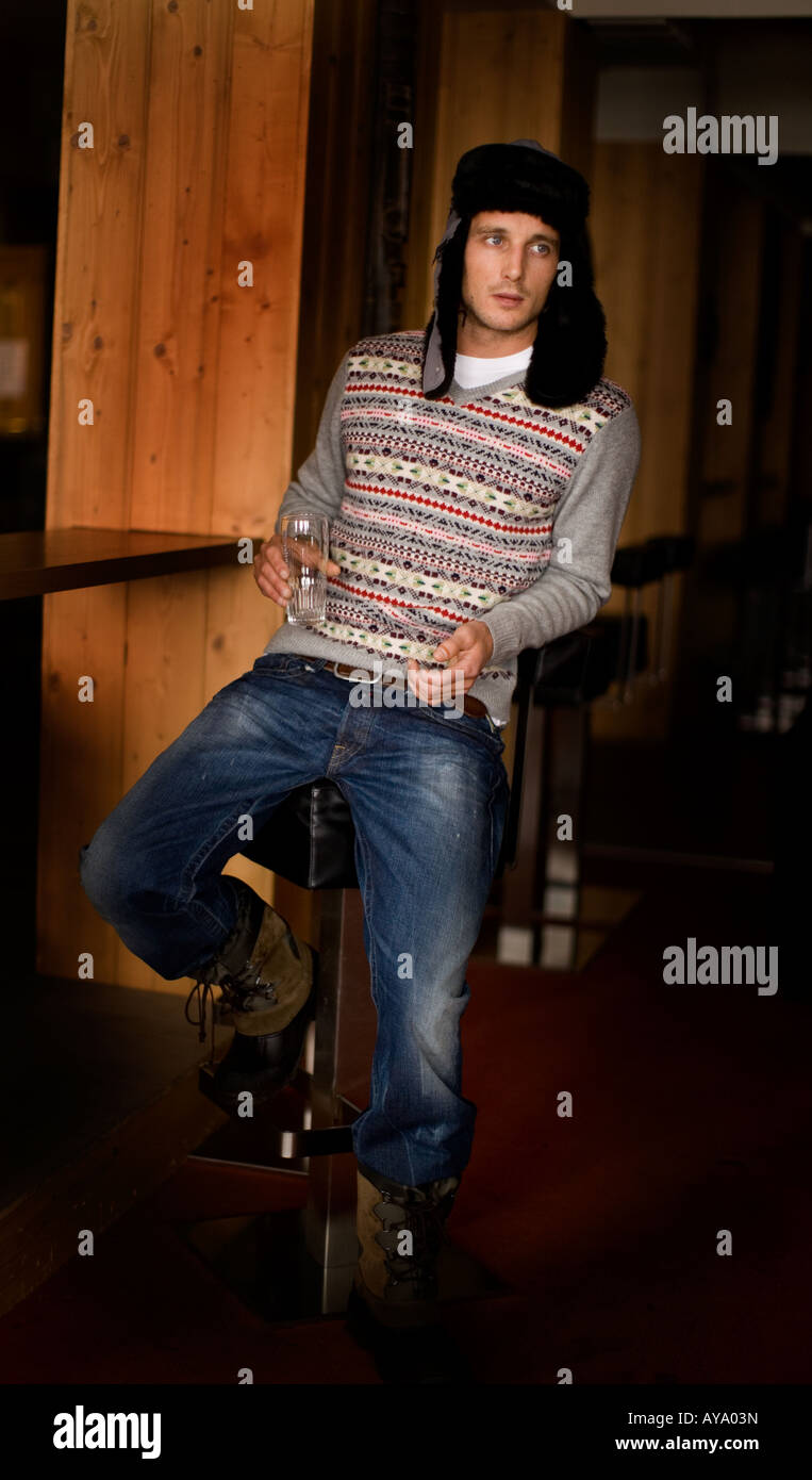 Man sitting with glass on bar stool, Apres ski, Tignes, France Stock Photo