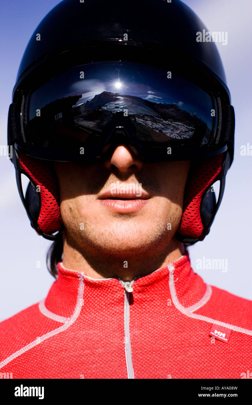 Skiing helmet with goggles reflecting mountains in Tignes, France Stock Photo