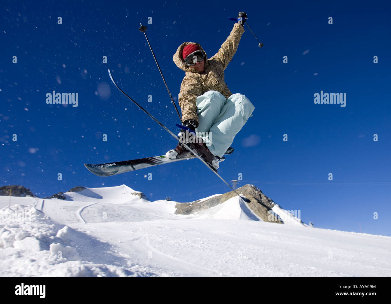 Skier in mid air stunt against blue sky, Tignes, France Stock Photo