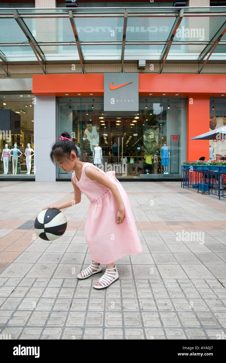 Asia China Beijing Young girls play basketball in front of Nike Store along pedestrian shopping street in Dong An Plaza Stock Photo Alamy