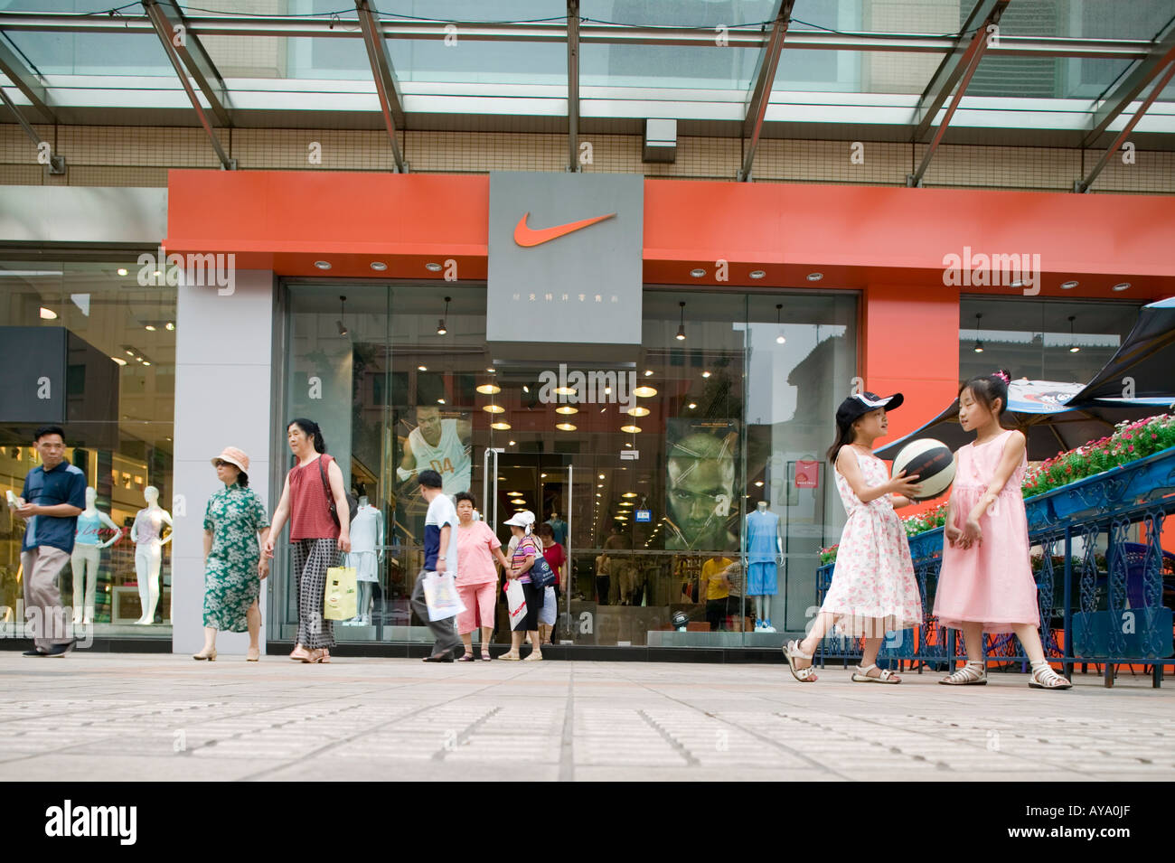 Asia China Beijing Young girls play basketball in front of Nike Store along  pedestrian shopping street in Dong An Plaza Stock Photo - Alamy