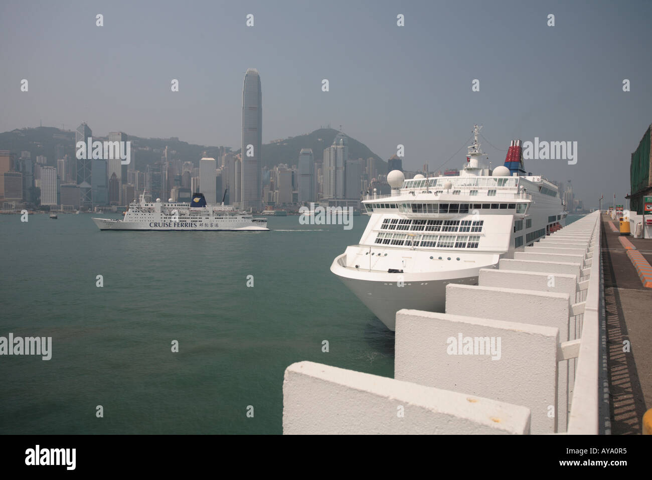 Asia Peoples Republic of China Hong Kong M V Wasa Queen sails past cruise ship moored along waterfront in Tsim Sha Tsui Stock Photo