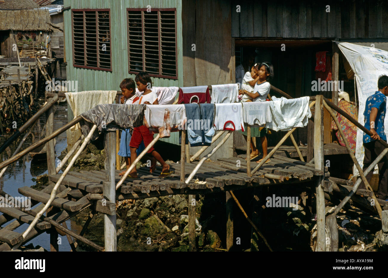 Tawi Tawi Thailand Village Life  Family Crossing Bridge  Washing Stock Photo