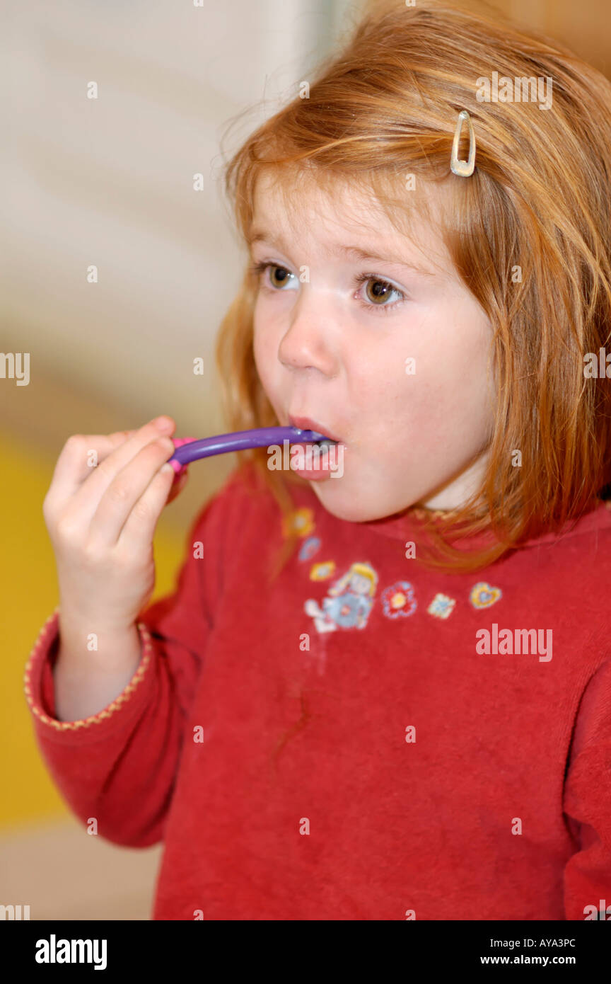 Girl 4 years old brushing her teeth Stock Photo