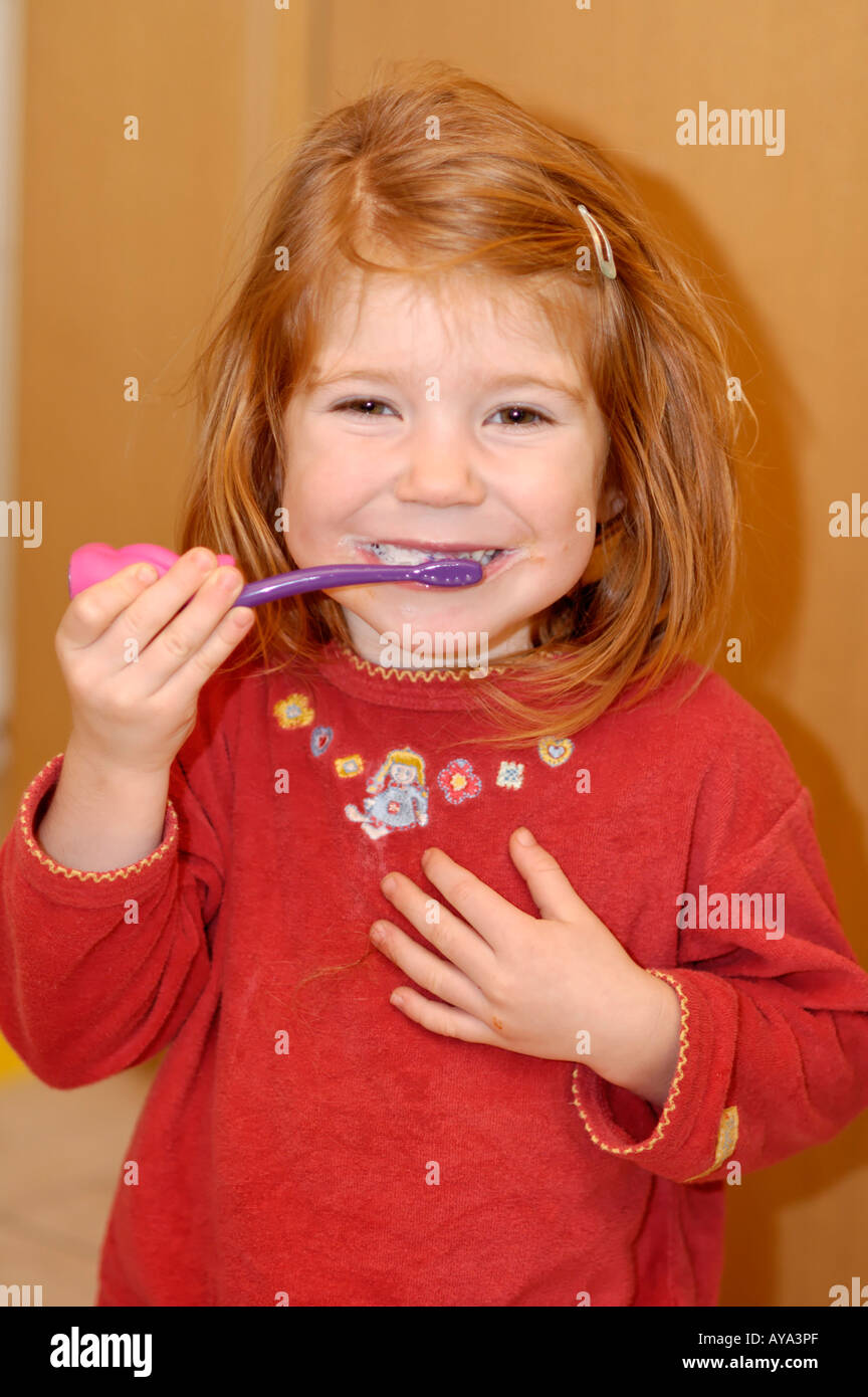 Girl 4 years old brushing her teeth Stock Photo
