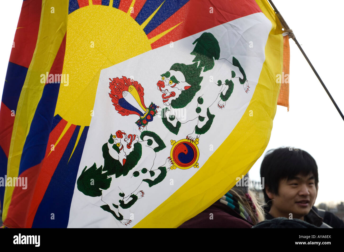 Free Tibet flag with Chinese person in background. Stock Photo