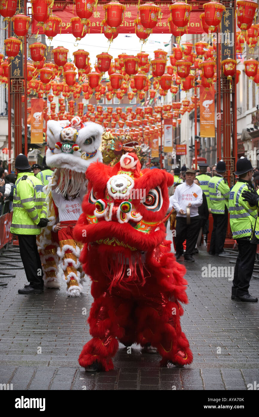 London's Chinatown lion welcomes the Chinese Beijing Olympic torch making its way through 31 miles of the capital's streets Stock Photo