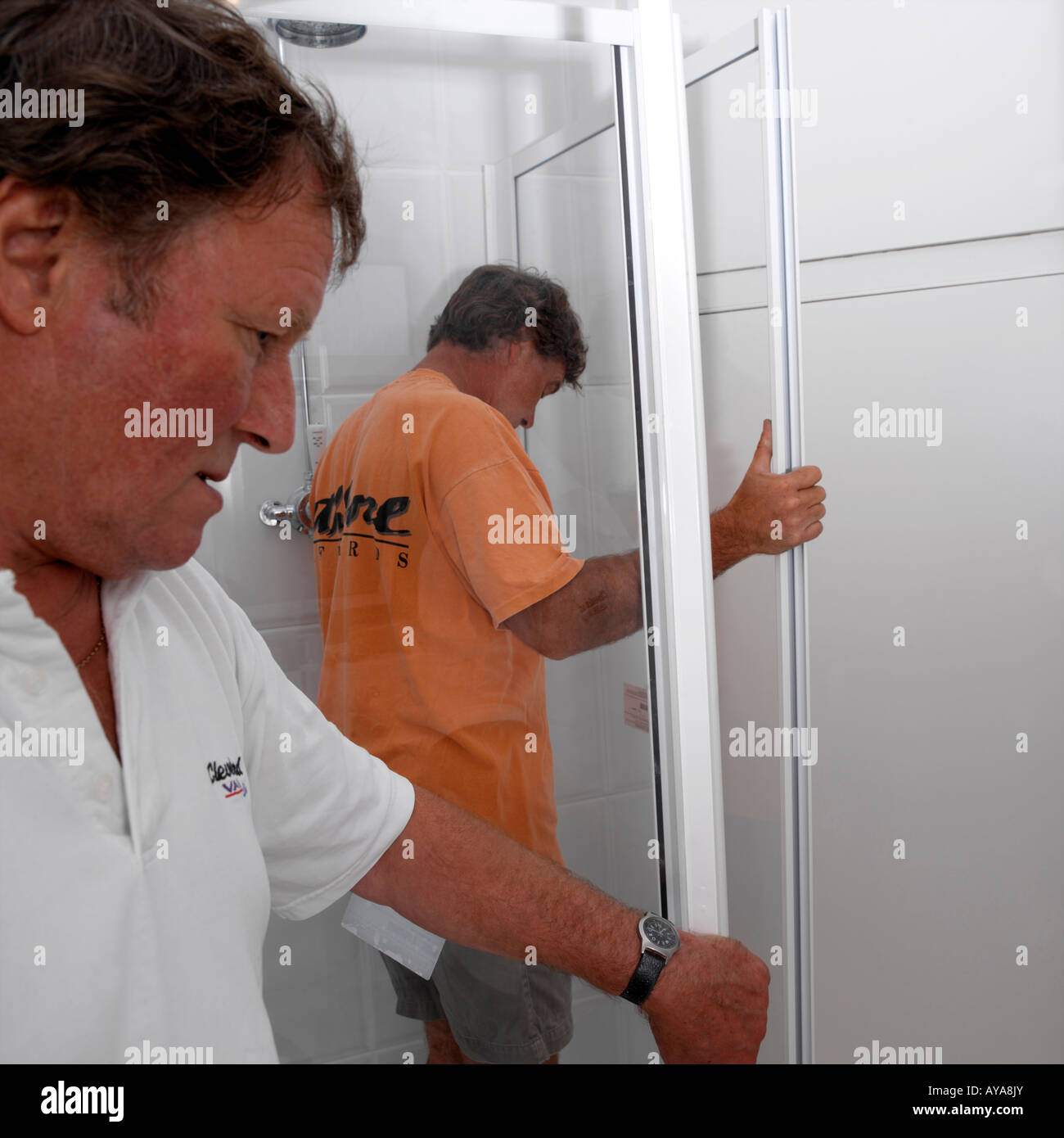 Fixing Shower Panels in New Bathroom Stock Photo