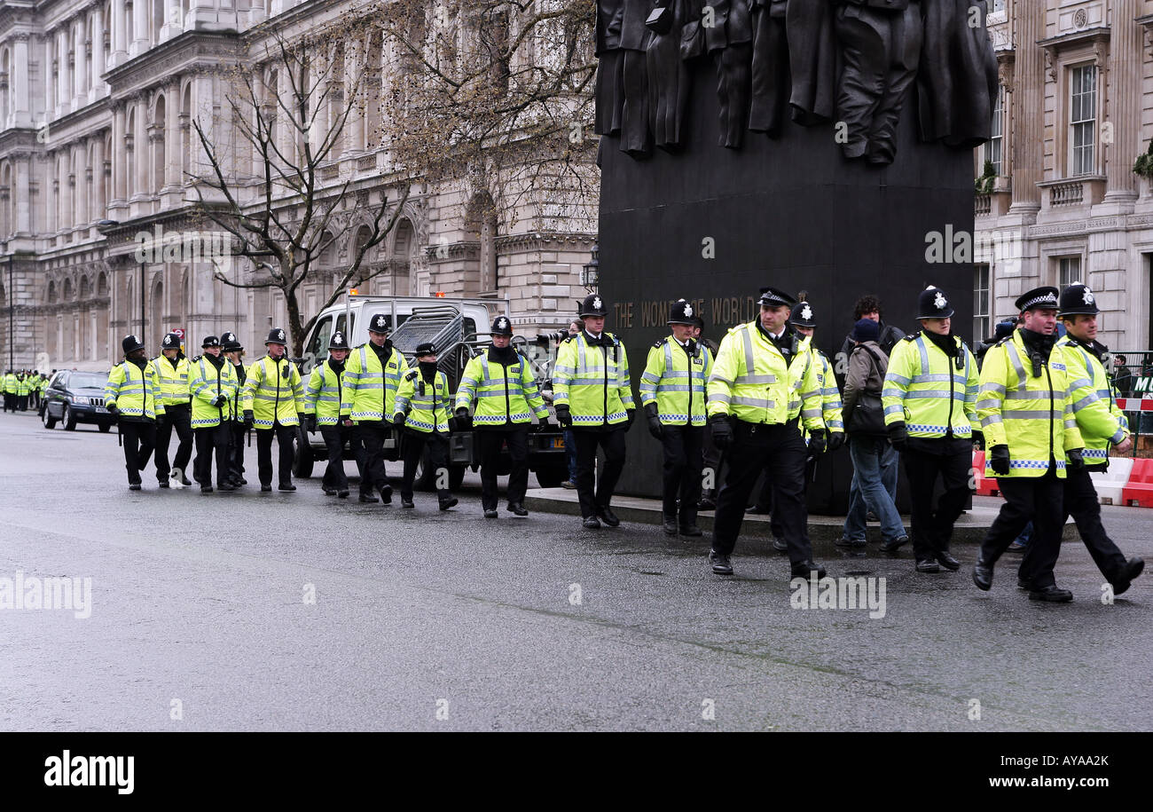 Police officers marching into position during anti-Olympic Games torch demonstration in London, UK Stock Photo