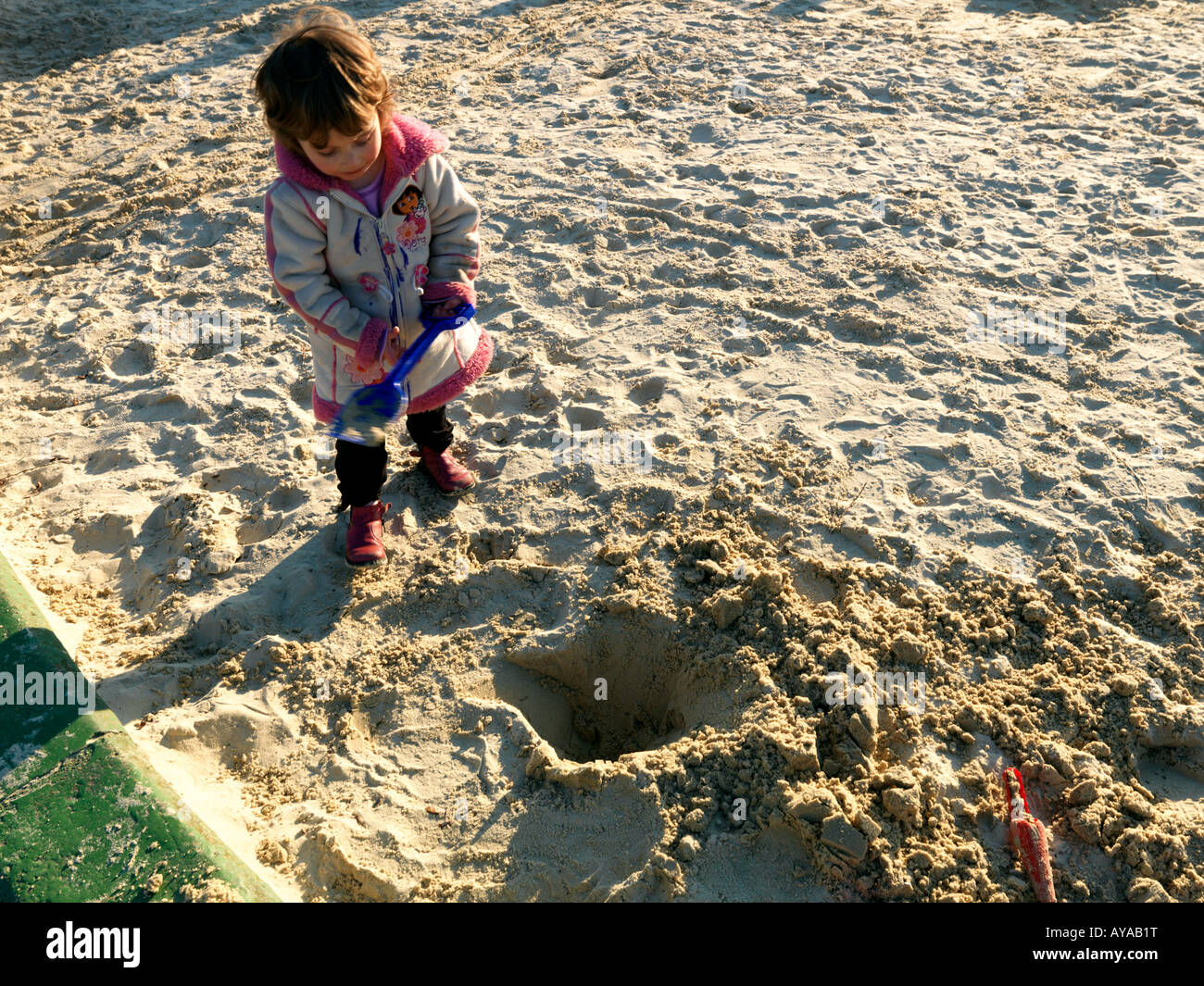 Child Digging Hole In Sandpit Stock Photo Alamy