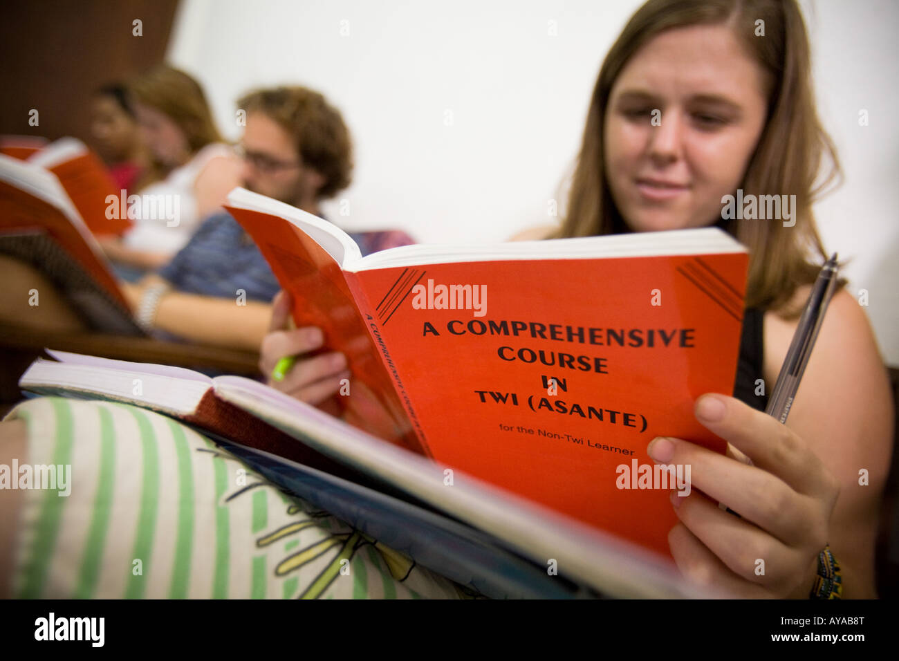 American student holds a textbook during a Twi a local language spoken in southern and central Ghana Stock Photo