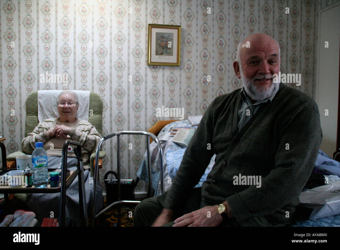 Man visiting old lady in Old persons home Stock Photo