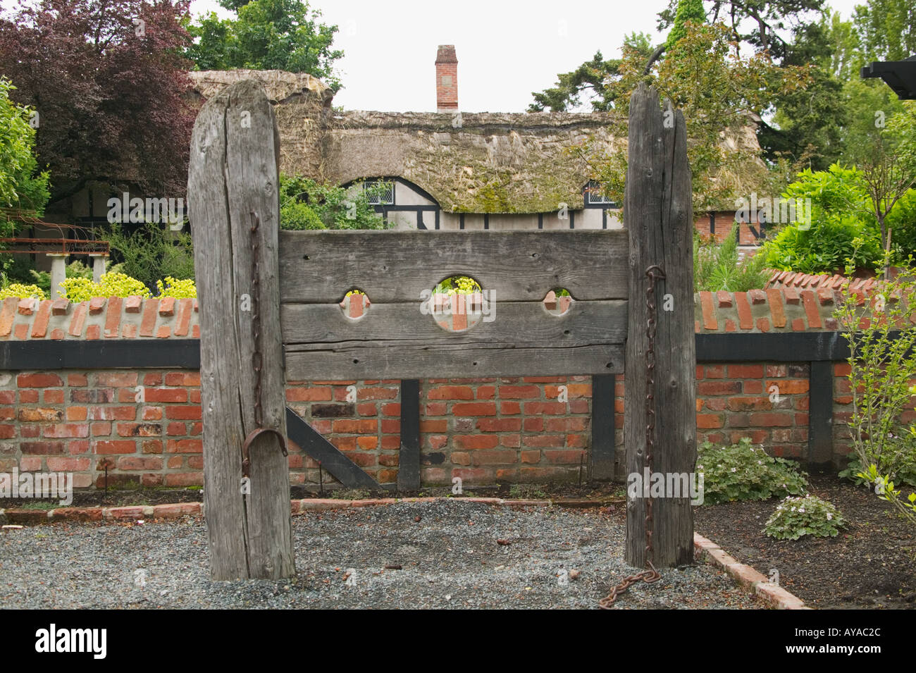 Stocks outside replica of Anne Hathaway's thatched roof cottage at the Old English Inn in Victoria British Columbia Canada Stock Photo