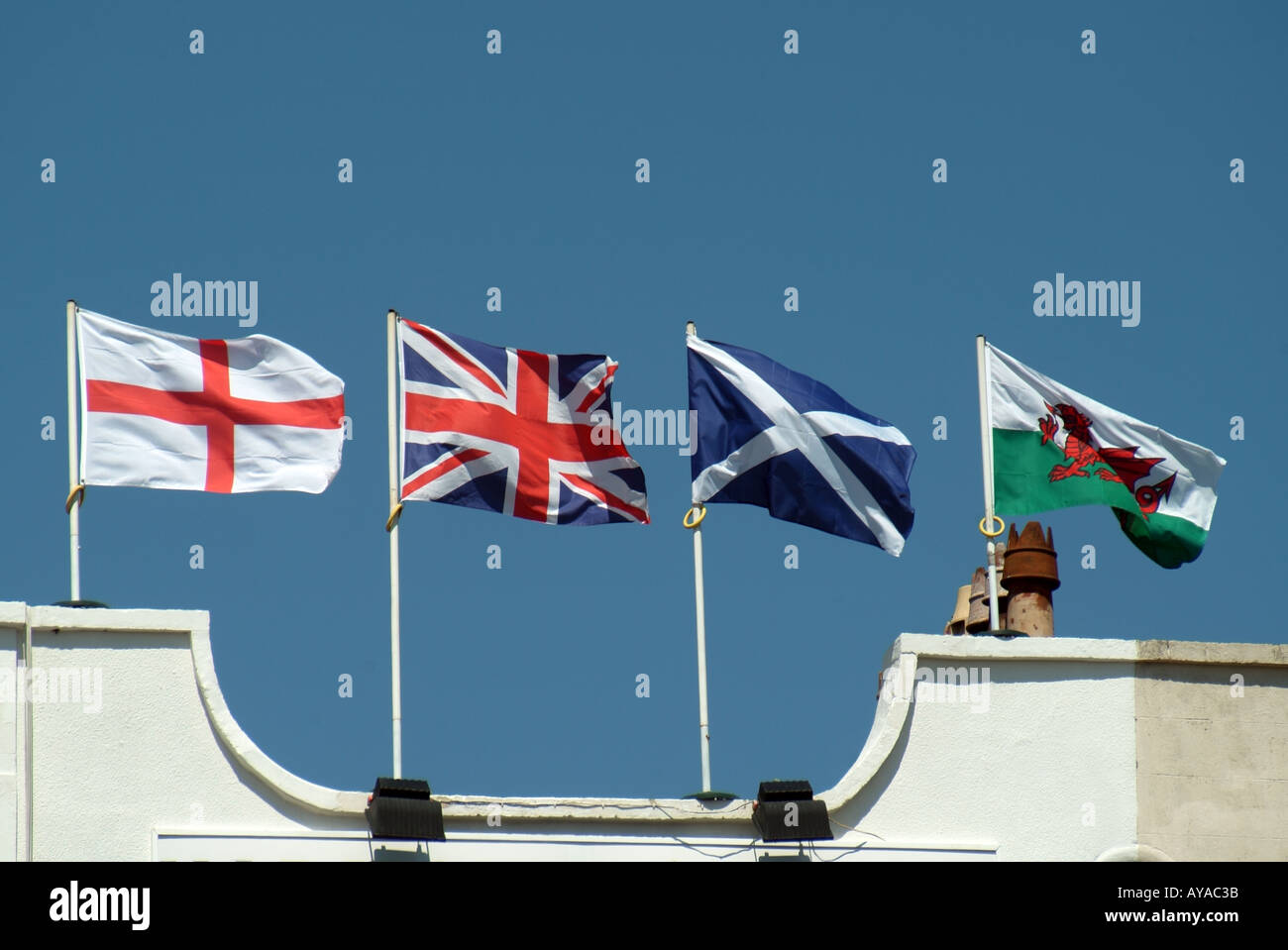 Weston Super Mare union flag & English Welsh Scottish flags flying together from top of building with Union Jack the wrong incorrect way up England UK Stock Photo