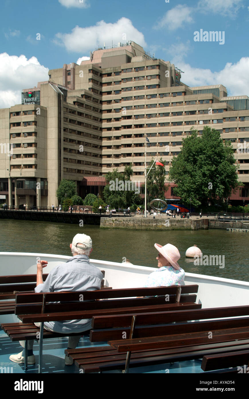 London river Thames tour boat passengers and the Guoman Tower Thistle hotel Stock Photo